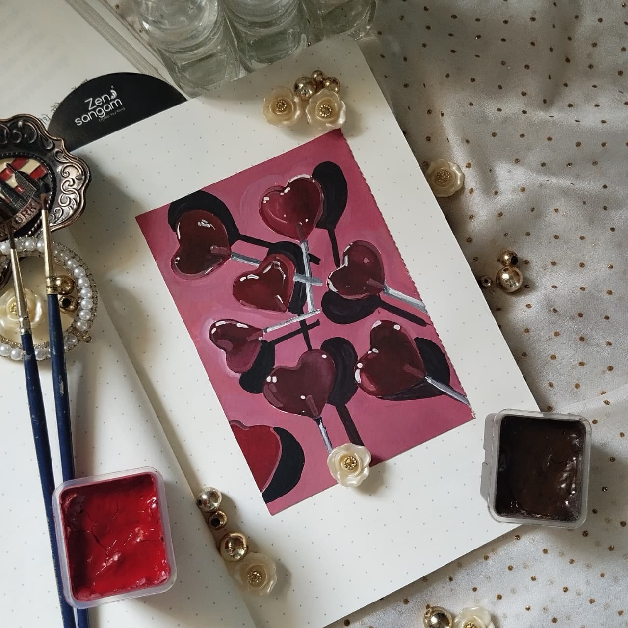 Painting of heart-shaped red lollipops
