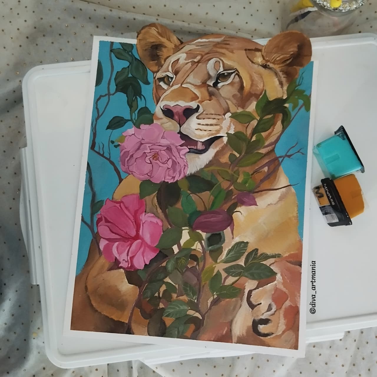 Painting of a lion surrounded by pink roses