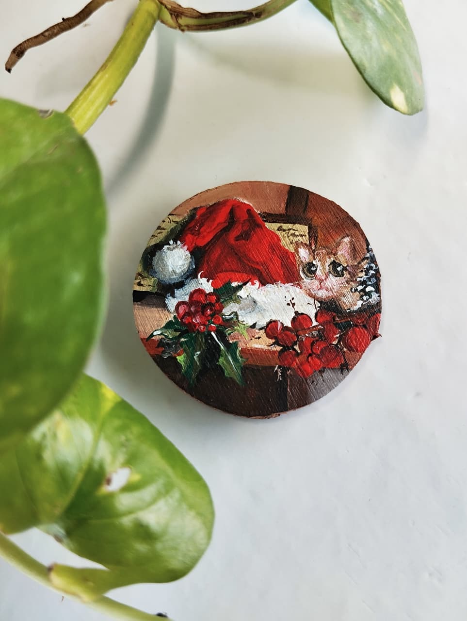 Miniature painting of a cat in a winter scene