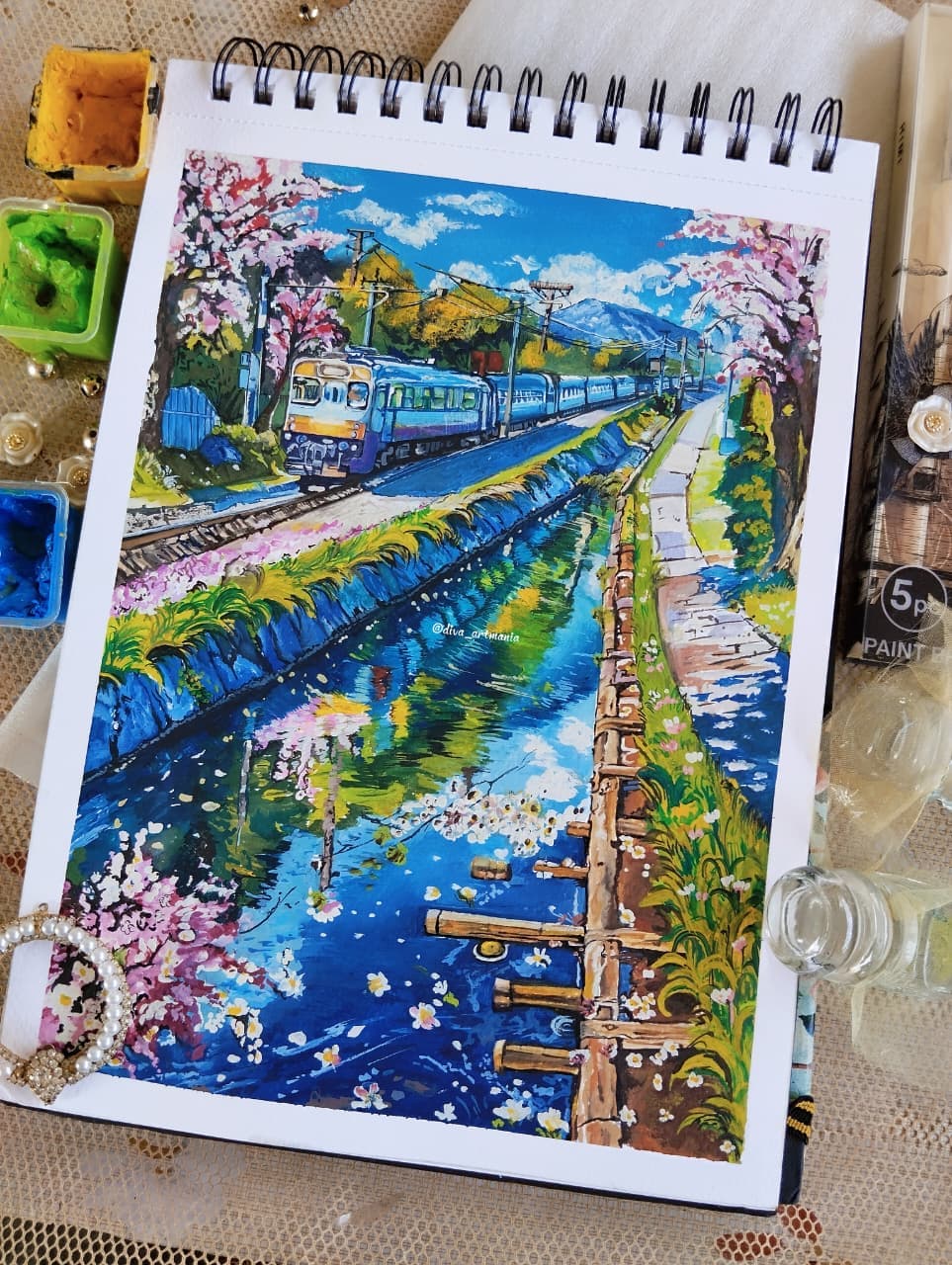 Painting of a train beside a canal with cherry blossoms